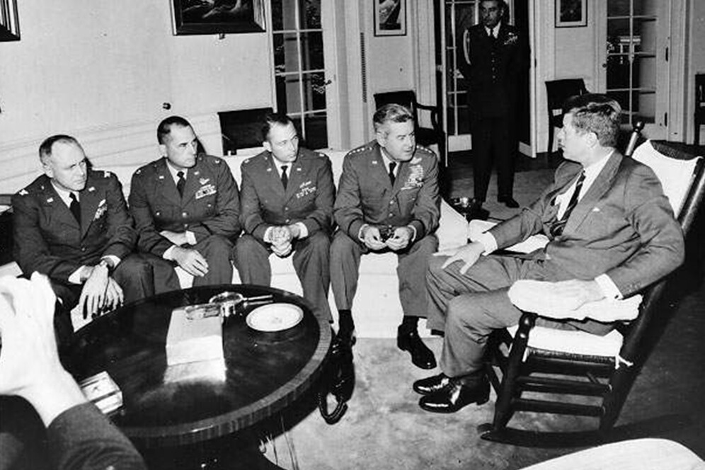 President Kennedy meets in the Oval Office with General Curtis LeMay and the reconnaissance pilots who found the missile sites in Cuba